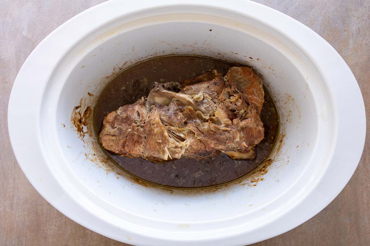 Slow cooker kalua pork before removing excess liquid and shredded the meat.