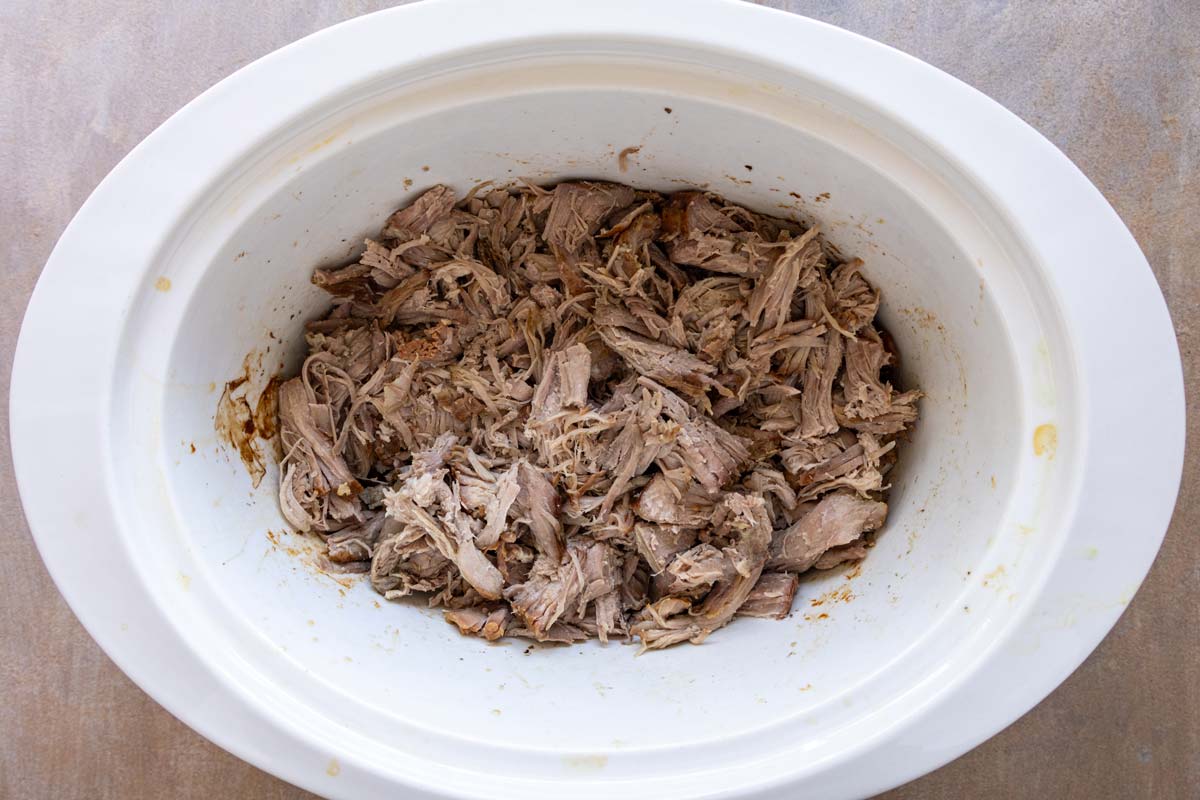 Shredded kalua pork in a slow cooker.