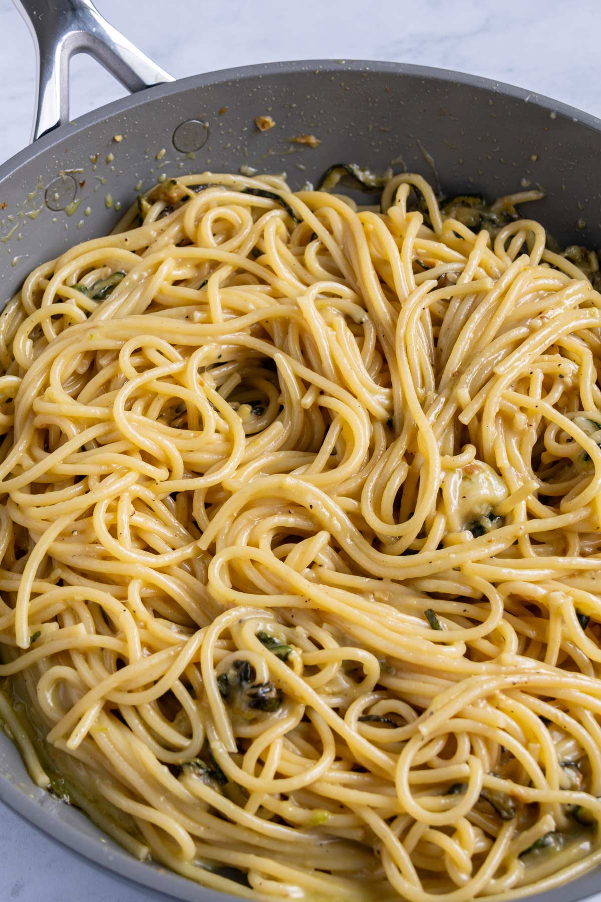 Silky and cheesy spaghetti alla nerano in a skillet.