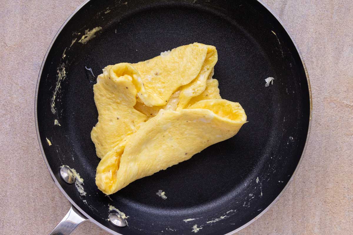 The four edges of an omelet folded toward the center to create kind of a square.